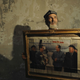 An ethnic Uighur resident shows a painting of China’s former leaders Zhu De, Zhou Enlai, Mao Zedong and Liu Shaoqi, at his home in Aksu, Xinjiang in 2012.